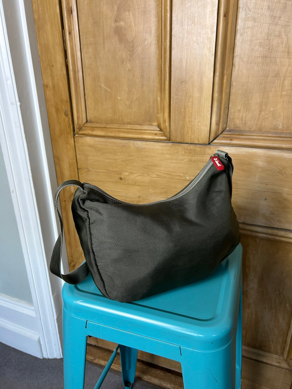 Khaki handbag with red accents