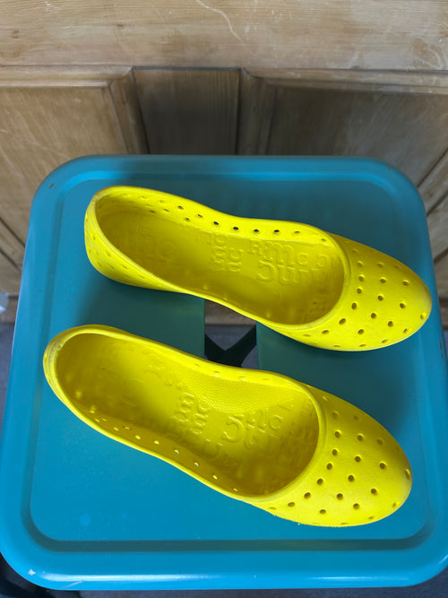 Bright yellow ballet flats