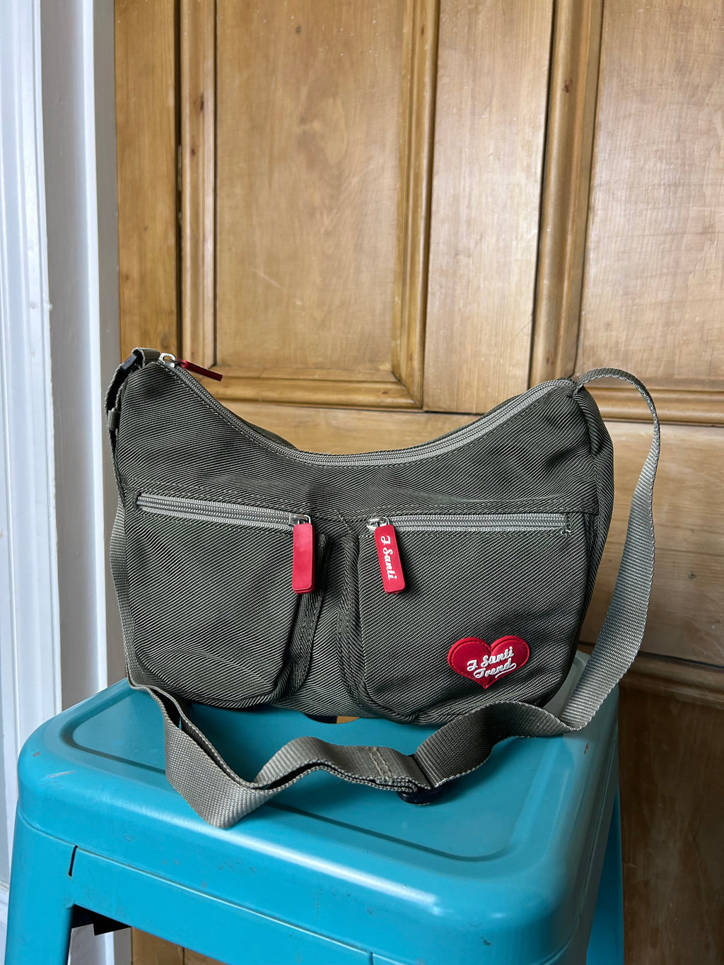 Khaki handbag with red accents