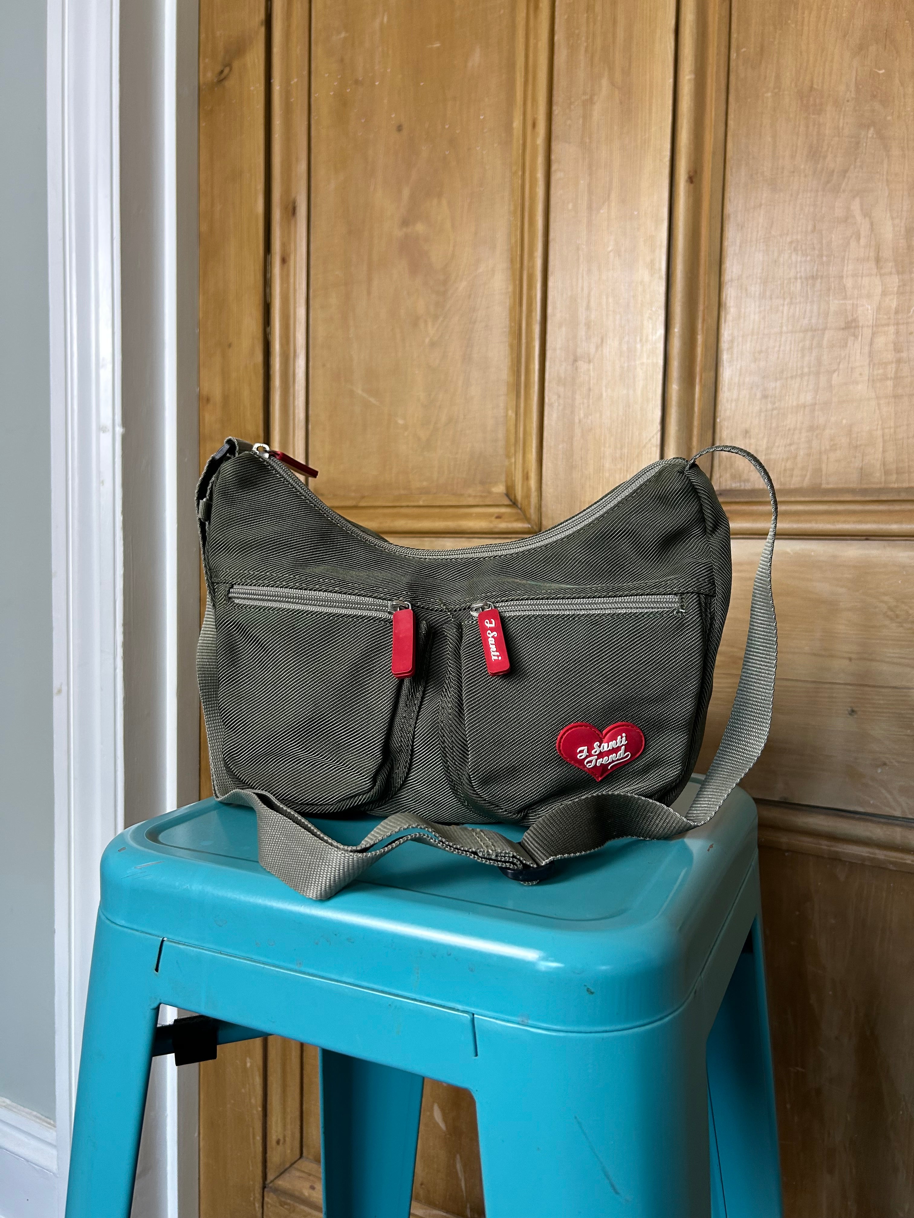 Khaki handbag with red accents